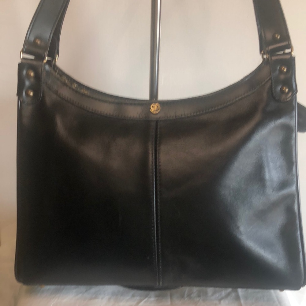 JOHN ROMAIN VINTAGE black shoulder handbag. Gold hardware with 5 feet at bottom.